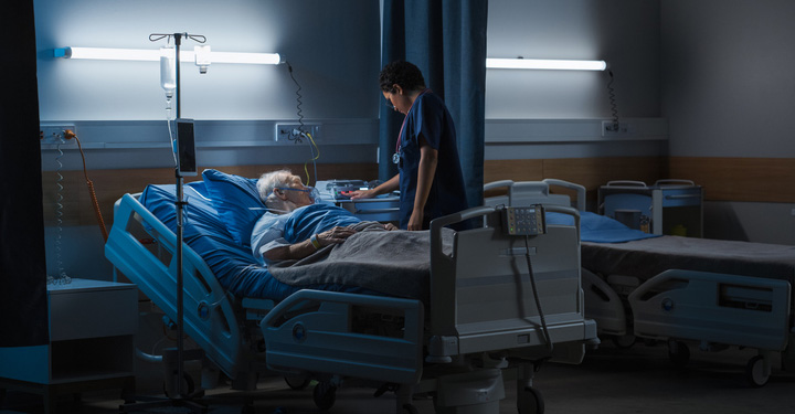Image of patient and nurse with calmer hospital lighting, helping to create a more relaxed healthcare system environment